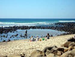 Gold Coast Beach at Burleigh with rocks and sand for family fun.